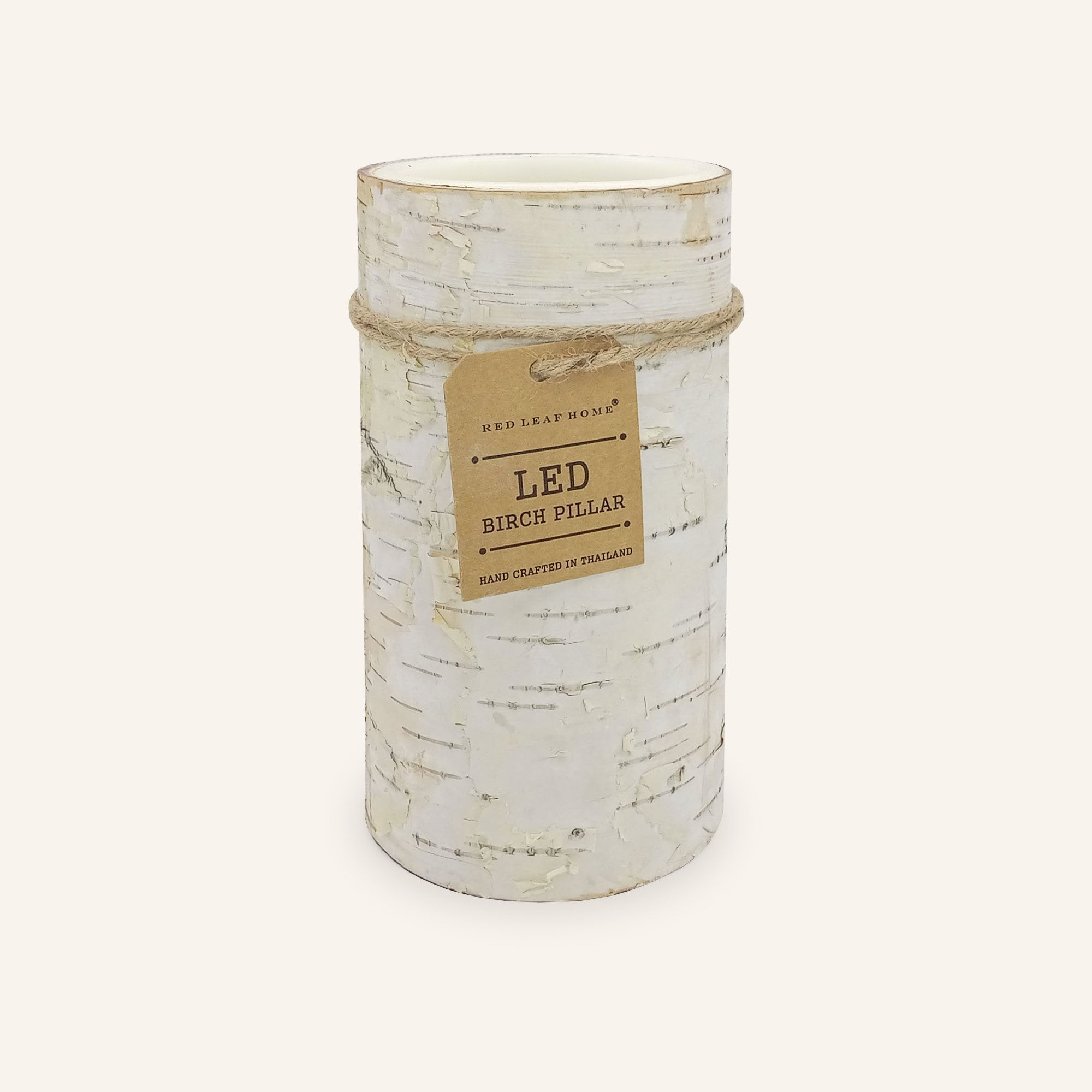 One birch-bark LED candle wrapped in a brown paper label that reads, "Red Leaf Home. LED Birch Pillars. Hand crafted in Thailand."