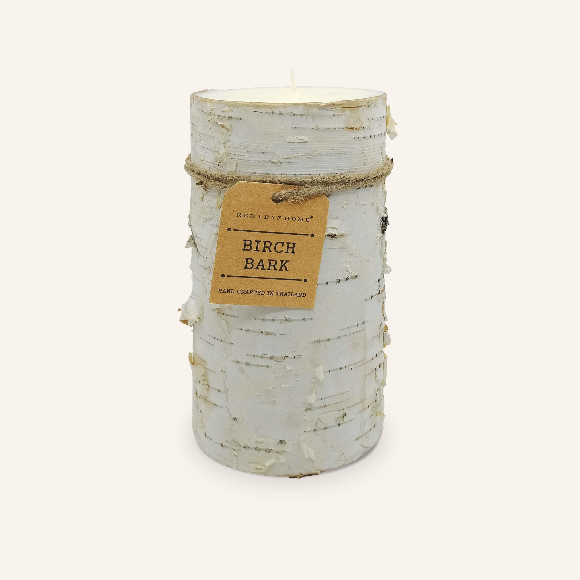 One Birch-bark candle with a brown paper label that reads, "Red Leaf Home. Birch Bark. Hand crafted in Thailand."